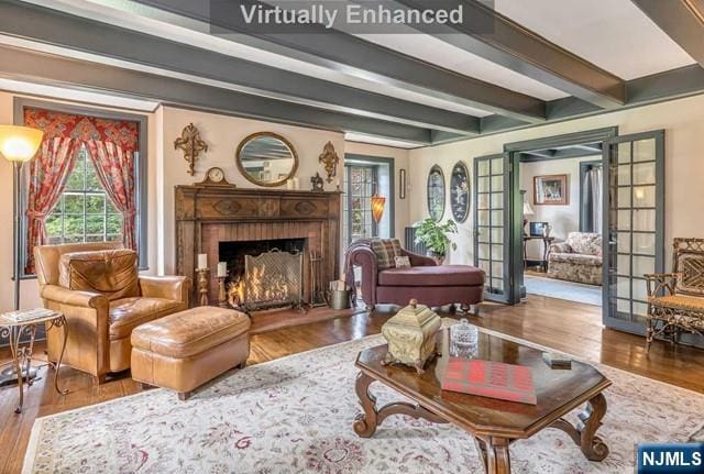 2 Wierimus Ln, Hillsdale, NJ 07642 - living area with french doors, wood finished floors, a warm lit fireplace, and beam ceiling