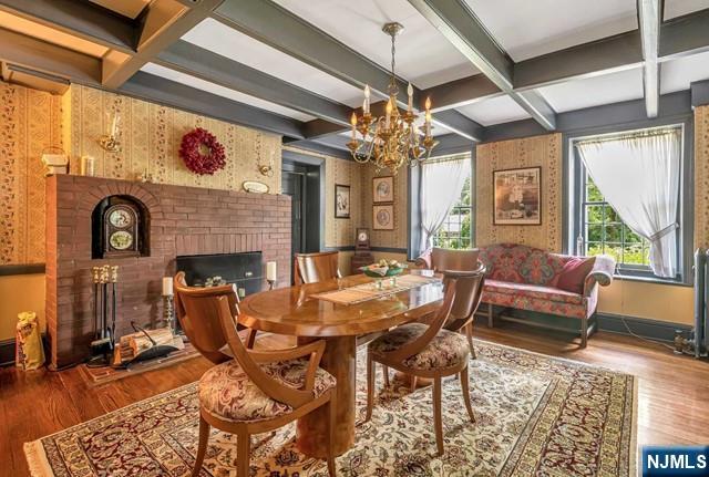 2 Wierimus Ln, Hillsdale, NJ 07642 - dining area featuring a fireplace, coffered ceiling, wood finished floors, and a chandelier