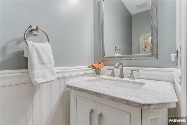 bathroom featuring vanity and wainscoting