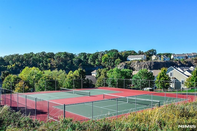 view of sport court featuring fence