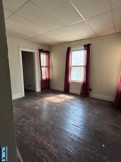 1 Reid Ave, Passaic, NJ 07055 - unfurnished room featuring baseboards, hardwood / wood-style flooring, and a paneled ceiling