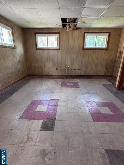 1 Reid Ave, Passaic, NJ 07055 - basement with a healthy amount of sunlight, tile patterned floors, and a paneled ceiling