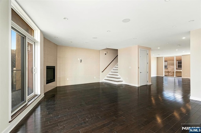 5-05 Washington Pl Unit 5-05, Cliffside Park, NJ 07010 - unfurnished living room with a fireplace, wood finished floors, stairway, baseboards, and recessed lighting