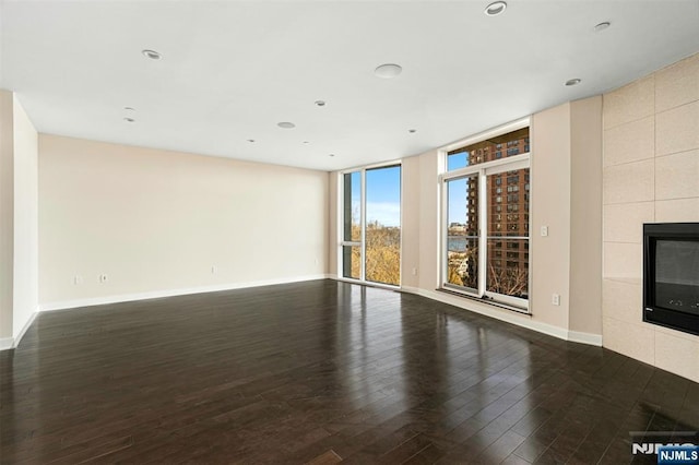 5-05 Washington Pl Unit 5-05, Cliffside Park, NJ 07010 - unfurnished living room featuring recessed lighting, baseboards, wood finished floors, and a fireplace