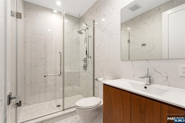 5-05 Washington Pl Unit 5-05, Cliffside Park, NJ 07010 - full bathroom with visible vents, vanity, toilet, tile walls, and a marble finish shower