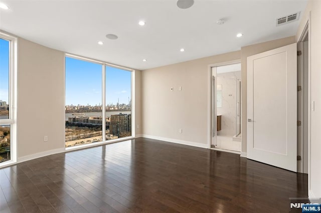5-05 Washington Pl Unit 5-05, Cliffside Park, NJ 07010 - unfurnished room featuring visible vents, a wall of windows, baseboards, recessed lighting, and dark wood finished floors