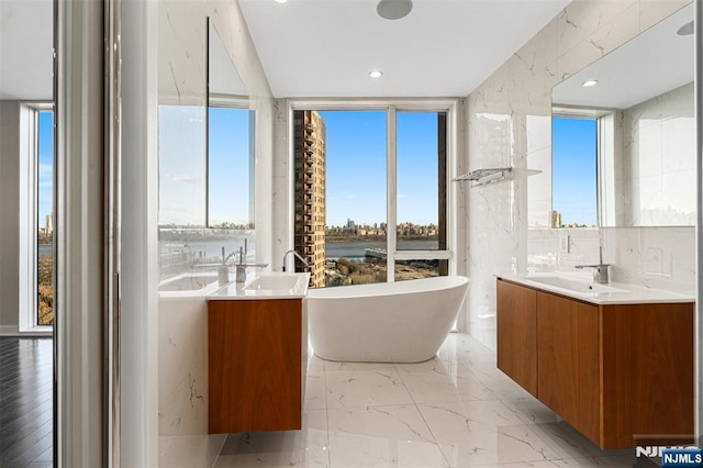 5-05 Washington Pl Unit 5-05, Cliffside Park, NJ 07010 - full bath featuring a water view, a wealth of natural light, a soaking tub, and vanity