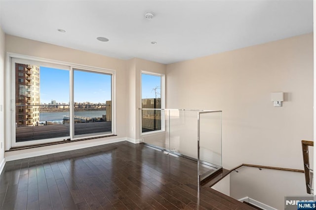 5-05 Washington Pl Unit 5-05, Cliffside Park, NJ 07010 - empty room with wood-type flooring, a water view, and baseboards