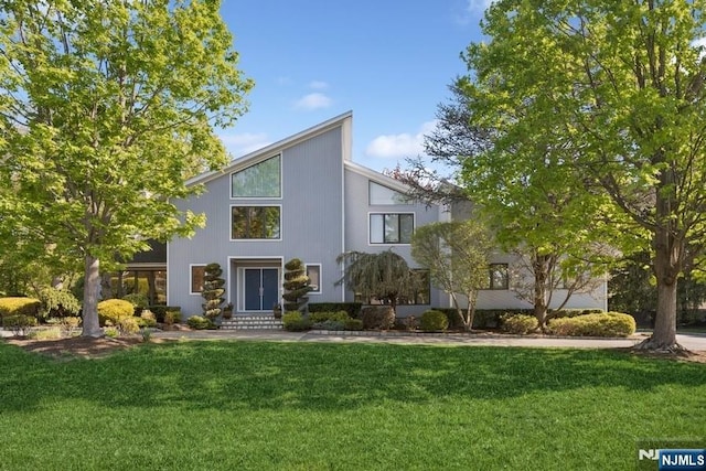 mid-century inspired home with a front lawn