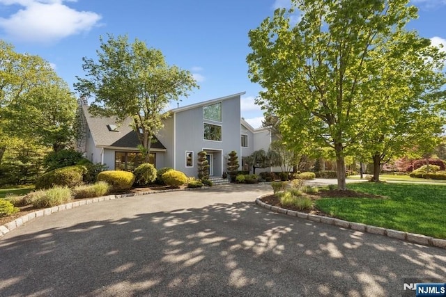 mid-century home featuring a front lawn