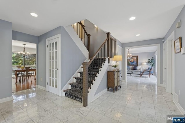 stairs featuring baseboards, recessed lighting, marble finish floor, and a chandelier
