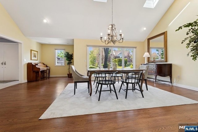dining area with a notable chandelier, recessed lighting, baseboards, wood finished floors, and a skylight
