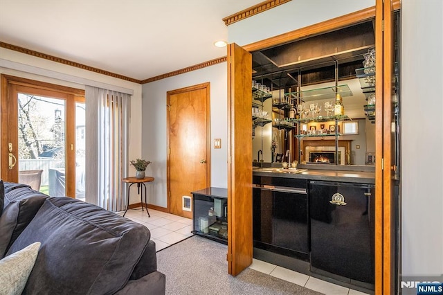 bar featuring crown molding, light tile patterned flooring, wet bar, and a sink