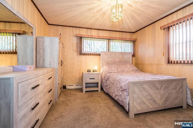 bedroom featuring crown molding, baseboard heating, wooden walls, an inviting chandelier, and carpet