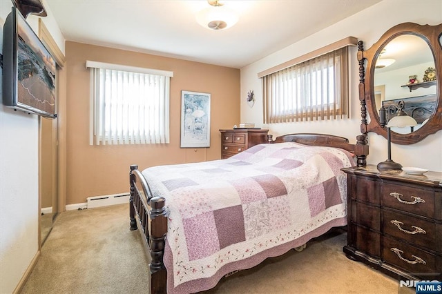 bedroom featuring a baseboard heating unit, baseboards, light colored carpet, and multiple windows
