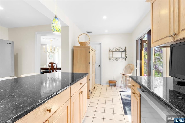 kitchen featuring an inviting chandelier, light brown cabinetry, recessed lighting, dark stone counters, and light tile patterned floors