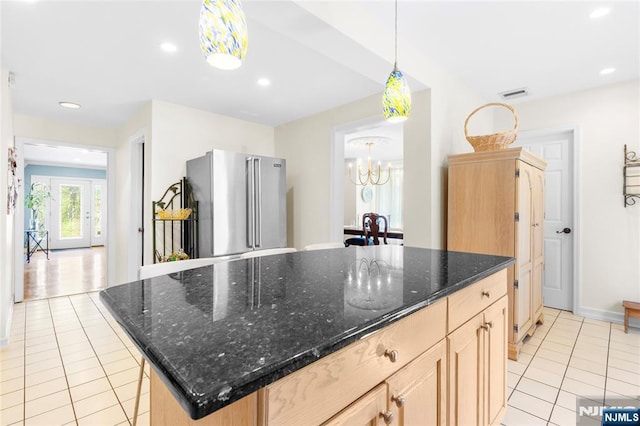 kitchen with visible vents, an inviting chandelier, light brown cabinetry, high quality fridge, and light tile patterned floors