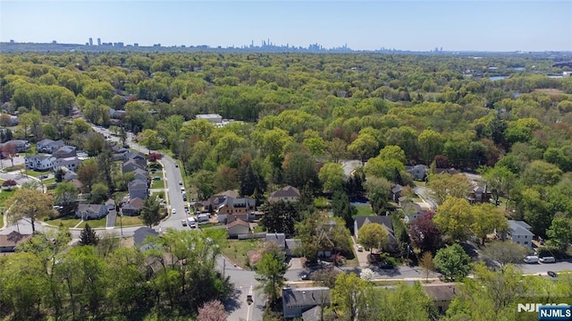 birds eye view of property featuring a view of trees and a residential view