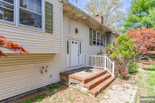 property entrance featuring a chimney