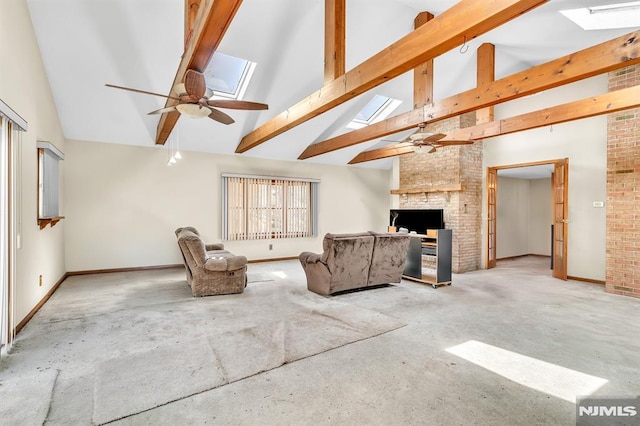 carpeted living room featuring ceiling fan, a skylight, and high vaulted ceiling