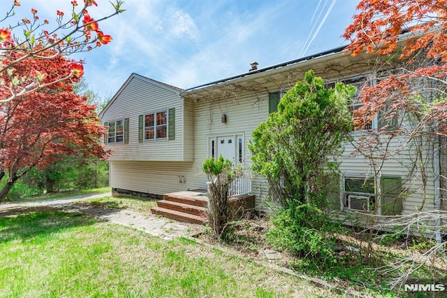 rear view of house featuring a yard