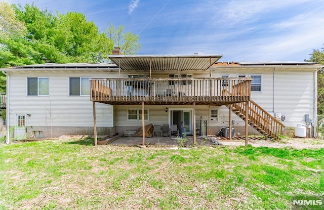 rear view of property with a patio, central AC unit, a lawn, and a deck