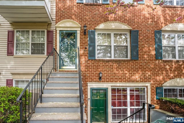view of exterior entry with brick siding
