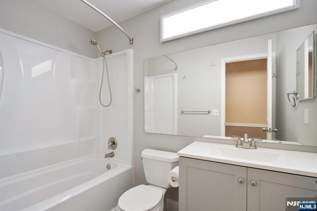 full bathroom featuring shower / bathtub combination, vanity, and toilet