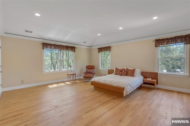 bedroom with visible vents, baseboards, multiple windows, and light wood-type flooring