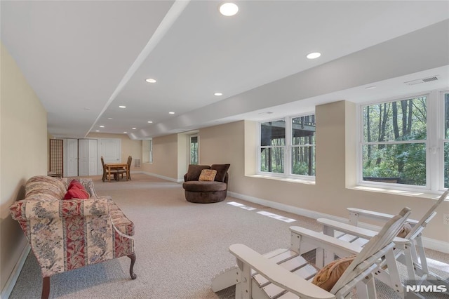 living area with recessed lighting, baseboards, visible vents, and carpet