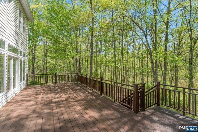 wooden deck with a view of trees