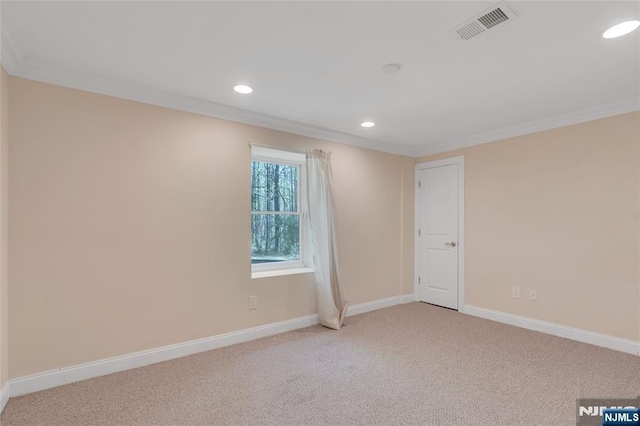 empty room featuring crown molding, recessed lighting, and visible vents