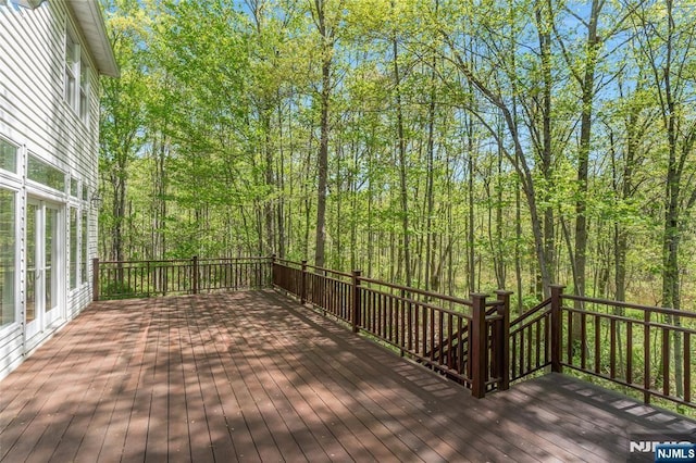 wooden deck with a view of trees