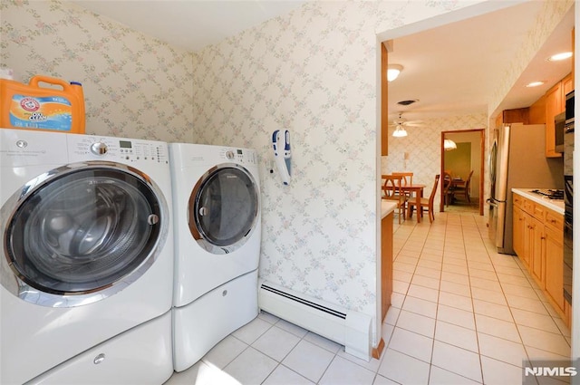 laundry room with a ceiling fan, washing machine and dryer, light tile patterned floors, a baseboard radiator, and wallpapered walls