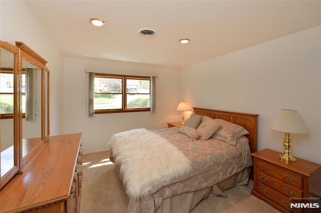 bedroom with recessed lighting, light colored carpet, and visible vents