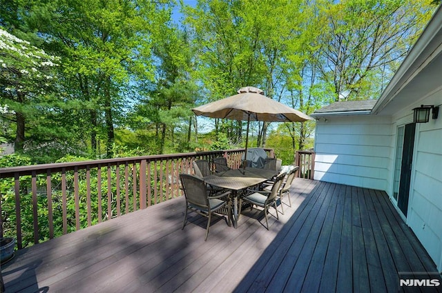 wooden terrace featuring outdoor dining area