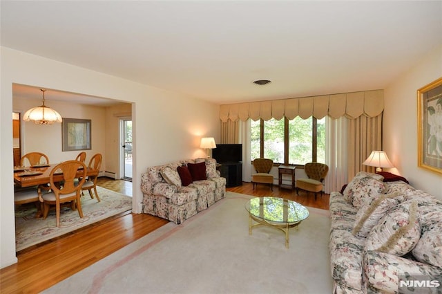 living area featuring visible vents, a wealth of natural light, and wood finished floors