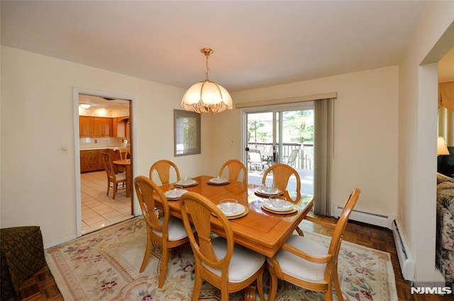 dining space featuring baseboards, a baseboard heating unit, an inviting chandelier, and a baseboard radiator
