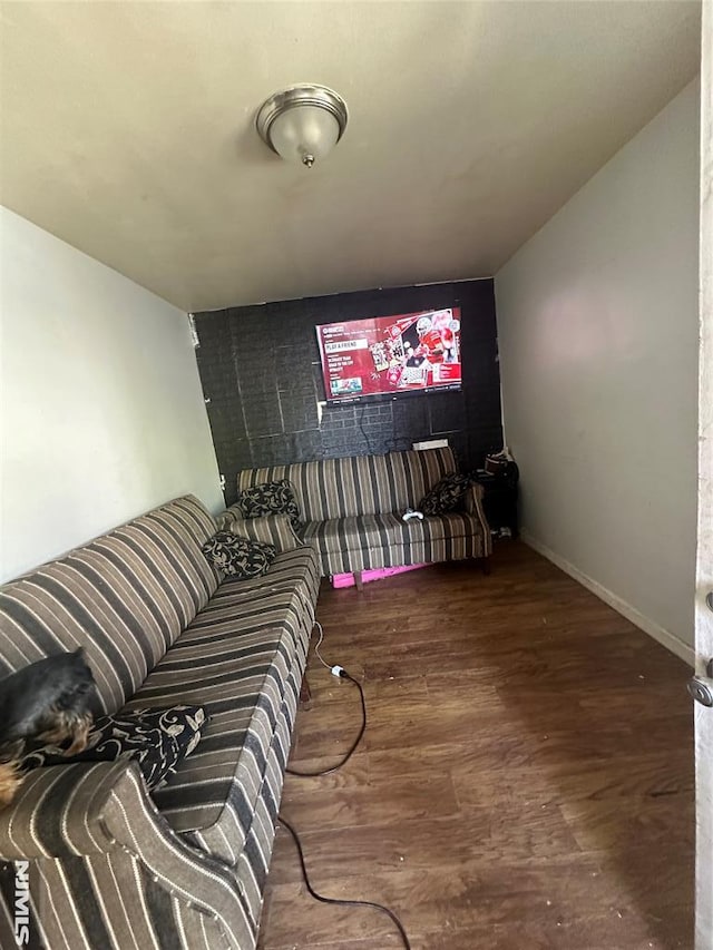 home theater with wood finished floors and baseboards