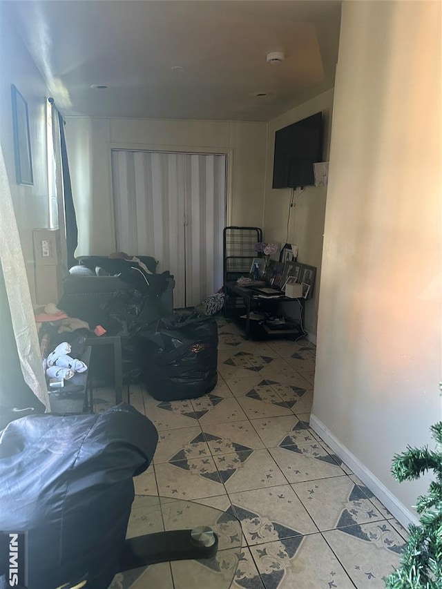 tiled living area with baseboards
