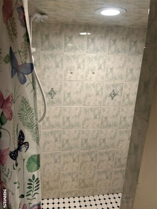 full bath with a tile shower
