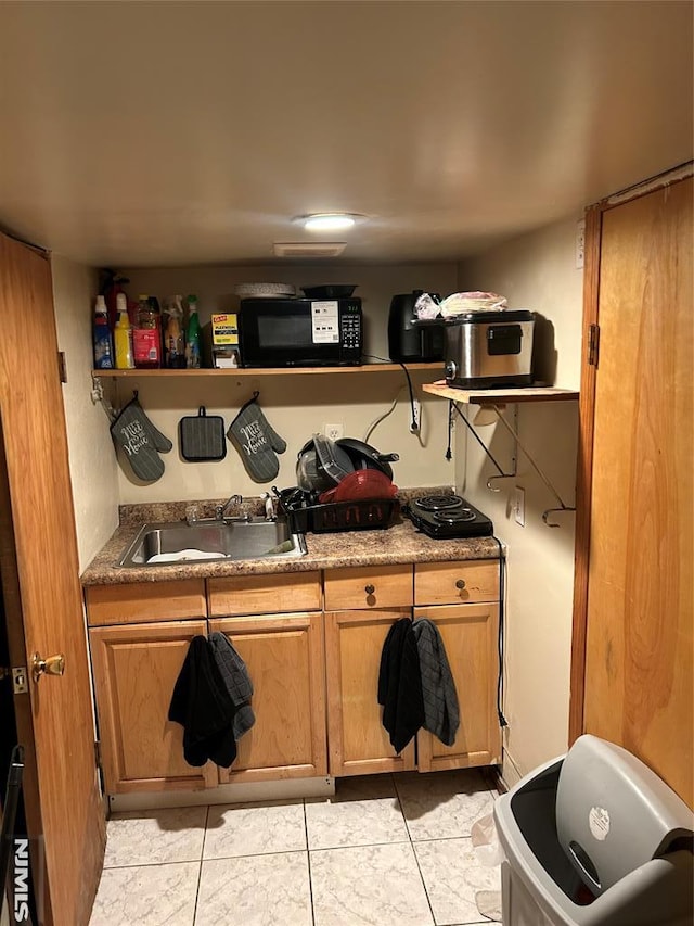 interior space with a sink and light tile patterned flooring