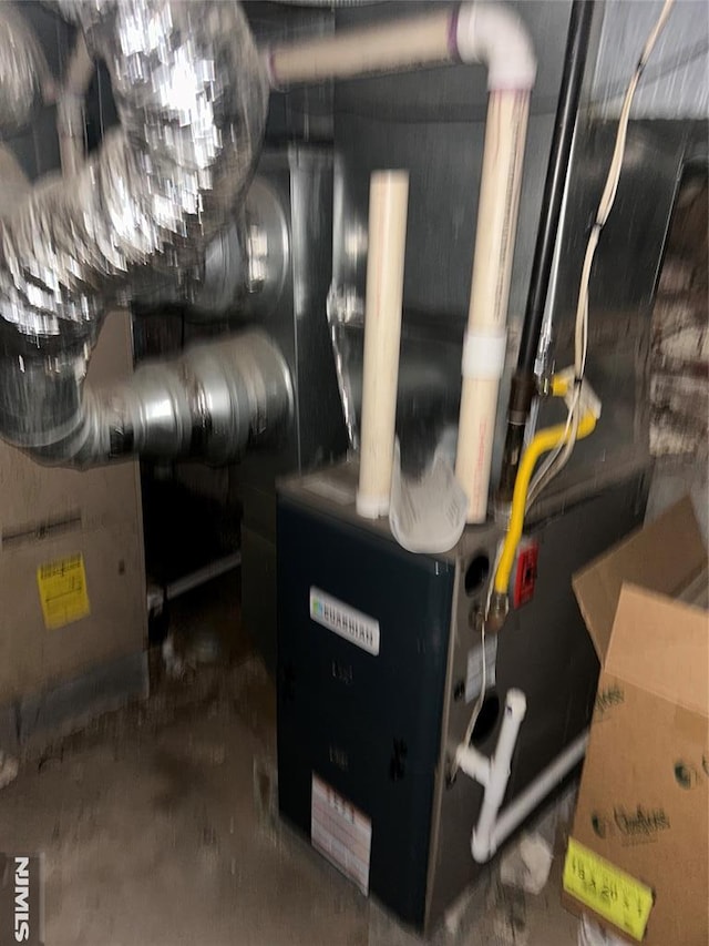utility room featuring heating unit