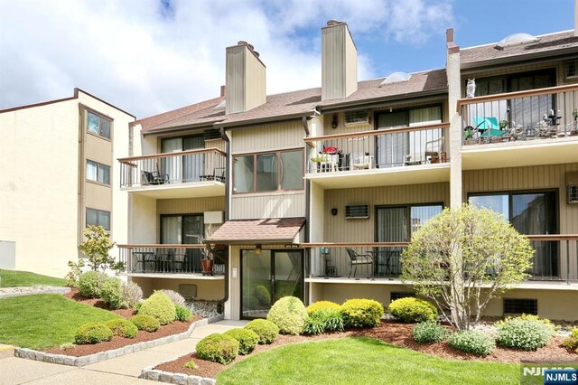 view of building exterior with an AC wall unit