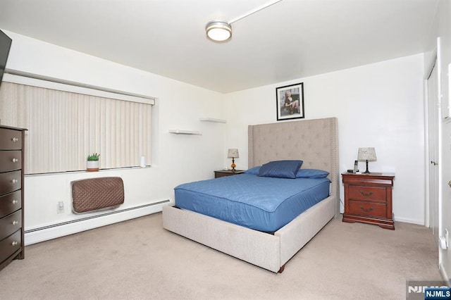 carpeted bedroom with a baseboard heating unit