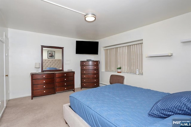 carpeted bedroom featuring baseboards and a baseboard radiator