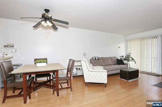 living room featuring a ceiling fan and light wood-style flooring
