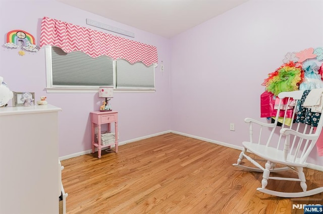 sitting room featuring baseboards and wood finished floors