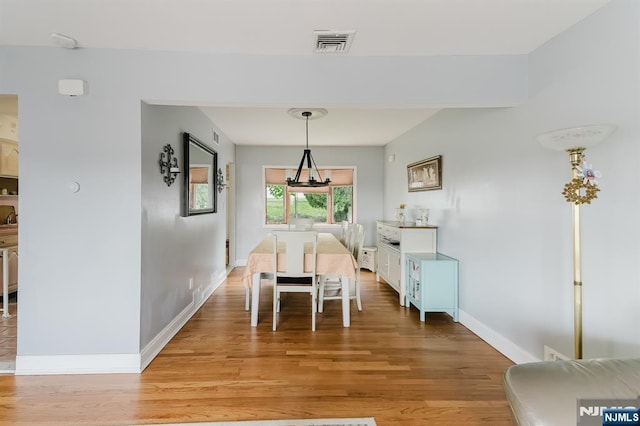 dining area with visible vents, baseboards, and light wood-type flooring