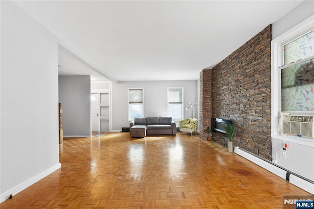 living area featuring baseboards and a baseboard heating unit